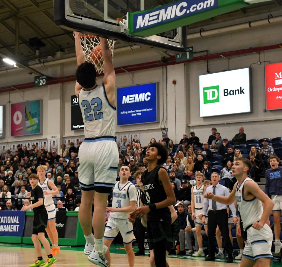 This dunk by York’s Lukas Bouchard (22) started a 14-0 fourth-quarter surge that led to a 50-37 win over Spruce Mountain in the Class B South quarterfinals Friday at the Portland Expo.