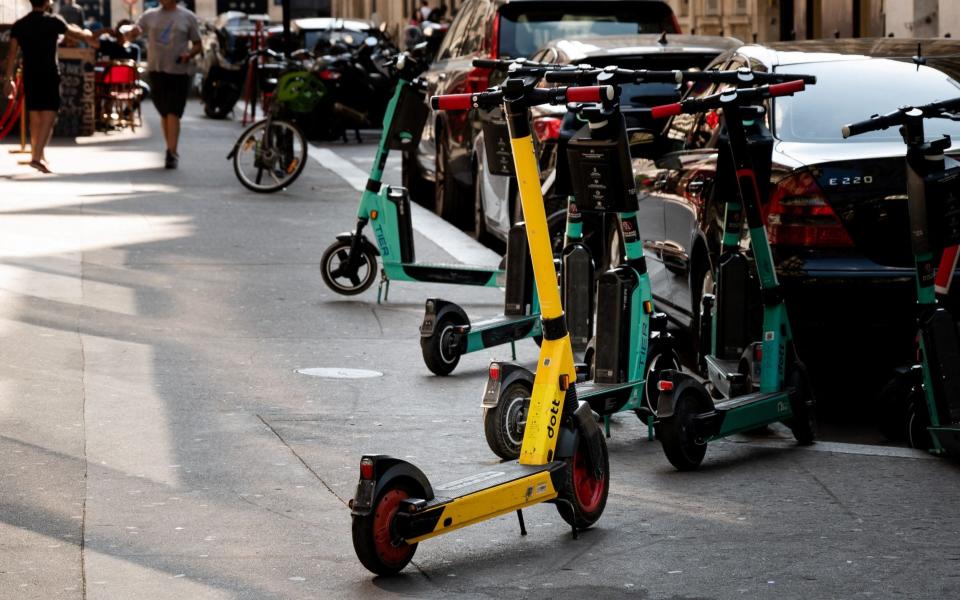 In this file photo taken on September , 2021, free floating rental electric scooters are seen on a sidewalk in Paris - AFP