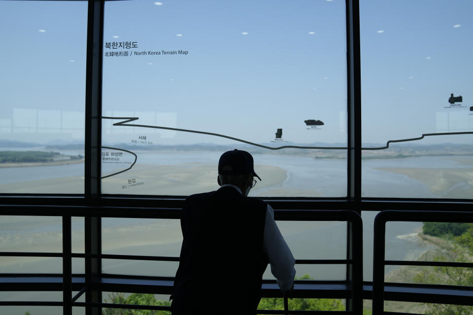 A Korean War veteran stands near a map of North Korea at the unification observatory in Paju, South Korea, Thursday, May 12, 2022. North Korea imposed a nationwide lockdown Thursday to control its first acknowledged COVID-19 outbreak after holding for more than two years to a widely doubted claim of a perfect record keeping out the virus that has spread to nearly every place in the world. (AP Photo/Lee Jin-man)