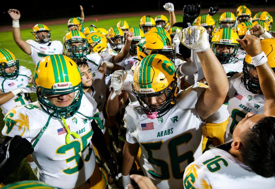 Coachella Valley players get a huddle and a break after their win at Palo Verde High School in Blythe, Calif., Friday, Aug. 25, 2023.
