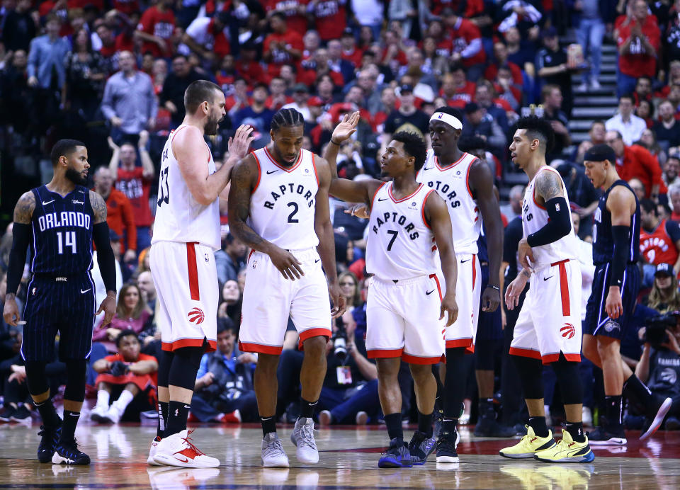 Kyle Lowry (7) of the Toronto Raptors high fives Marc Gasol (33) during Game 2. (Photo by Vaughn Ridley/Getty Images)