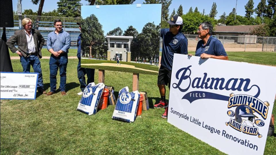 Event VIPs unveil a rendering for a new snack bar, press box and restroom facility at Bakman Field in Fresno’s Sunnyside area on Tuesday, July 11, 2023.