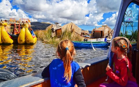 The Frias Family, keen members of the Our Tribe Travels community, soak up Lake Titicaca in Peru