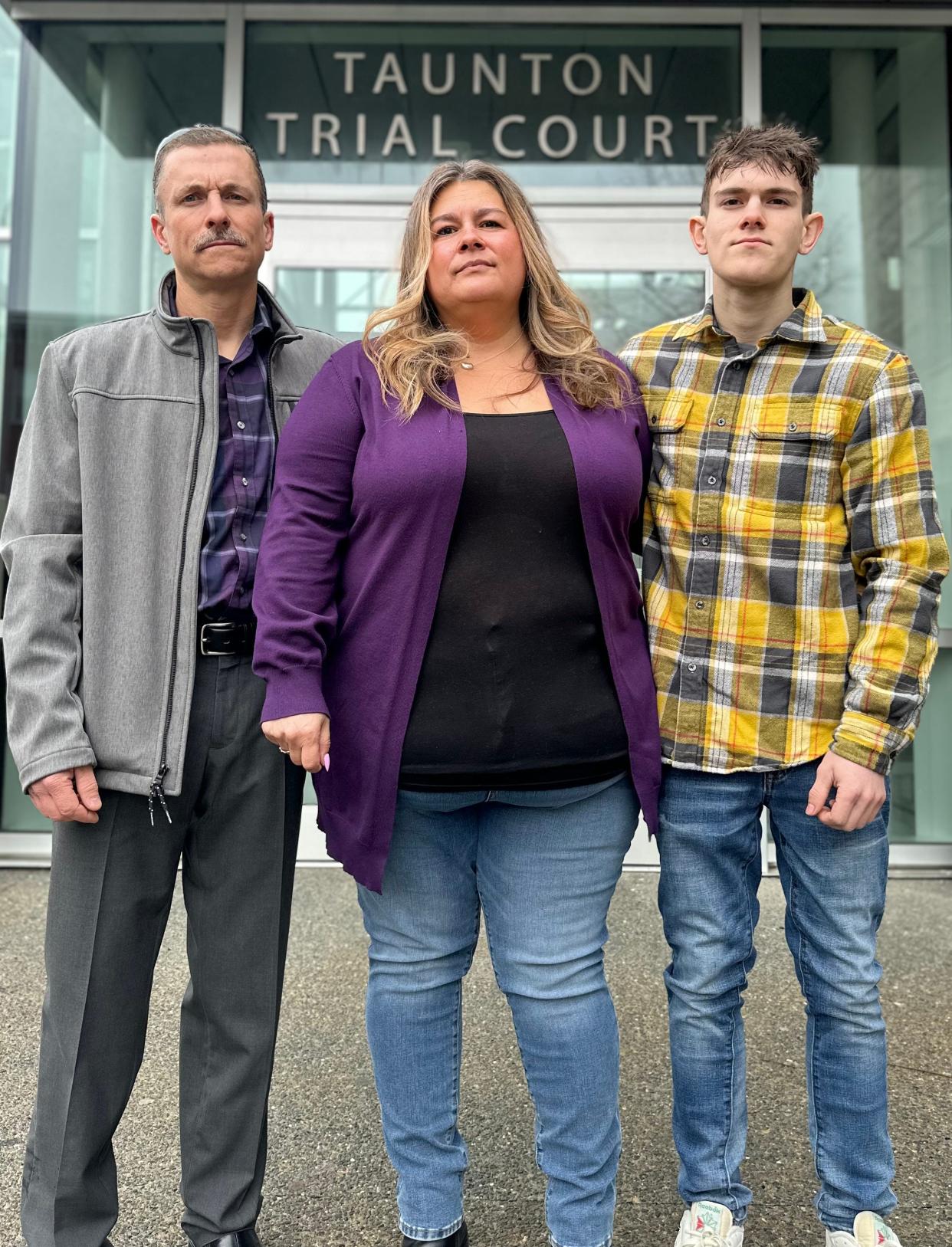 Daniel Carrier, Melanie Mott and their son, Dan, stand outside Taunton Trial Court in Massachusetts.