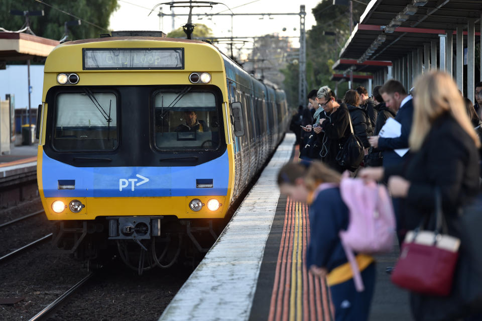 Peak hour commuters wait for a city loop train at Newmarket Station in Melbourne.