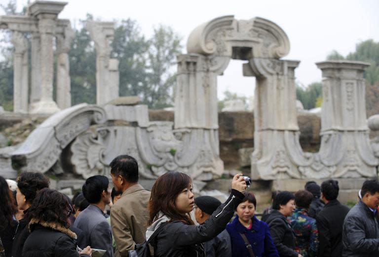 Visitors look at the Guanshuifa Fountain which was built in 1759 during the period of Qing Emperor Qianlong, at the Old Summer Palace in Beijing, in 2010