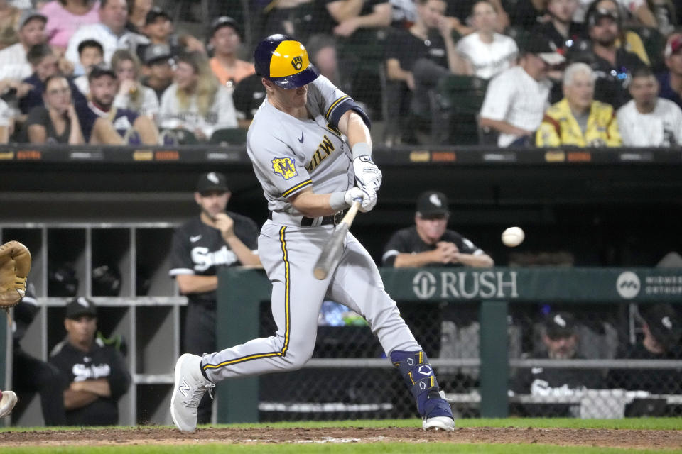 Milwaukee Brewers' Mark Canha hits an RBI double off Chicago White Sox relief pitcher Jimmy Lambert during the 10th inning of a baseball game Friday, Aug. 11, 2023, in Chicago. The Brewers won 7-6. (AP Photo/Charles Rex Arbogast)