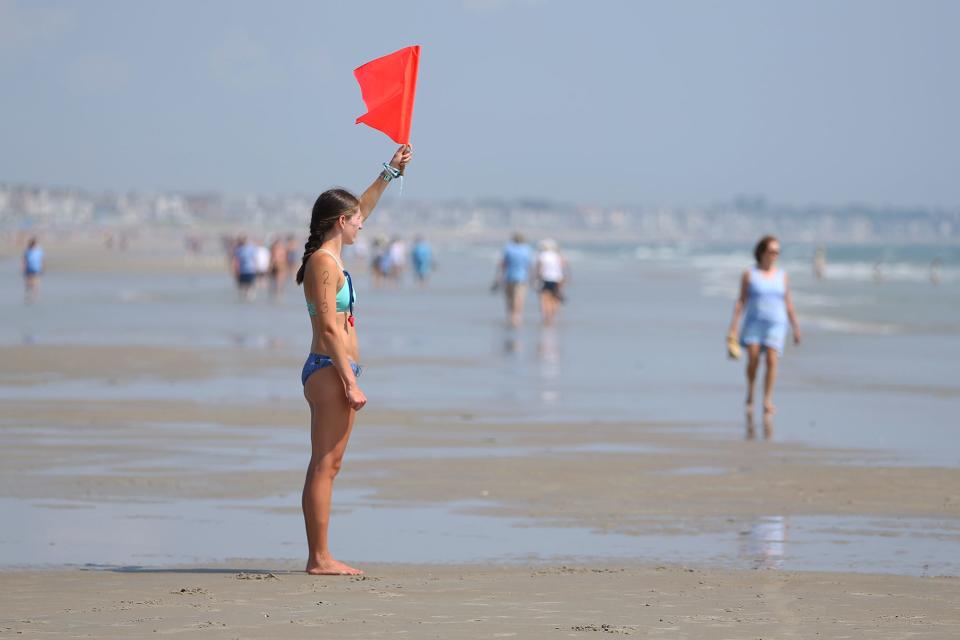 Lifeguards signal checkpoints to competitors during the 2021 Northeastern Lifesaving Competition on Thursday, Aug. 12, 2021, at Ogunquit Beach in Maine.