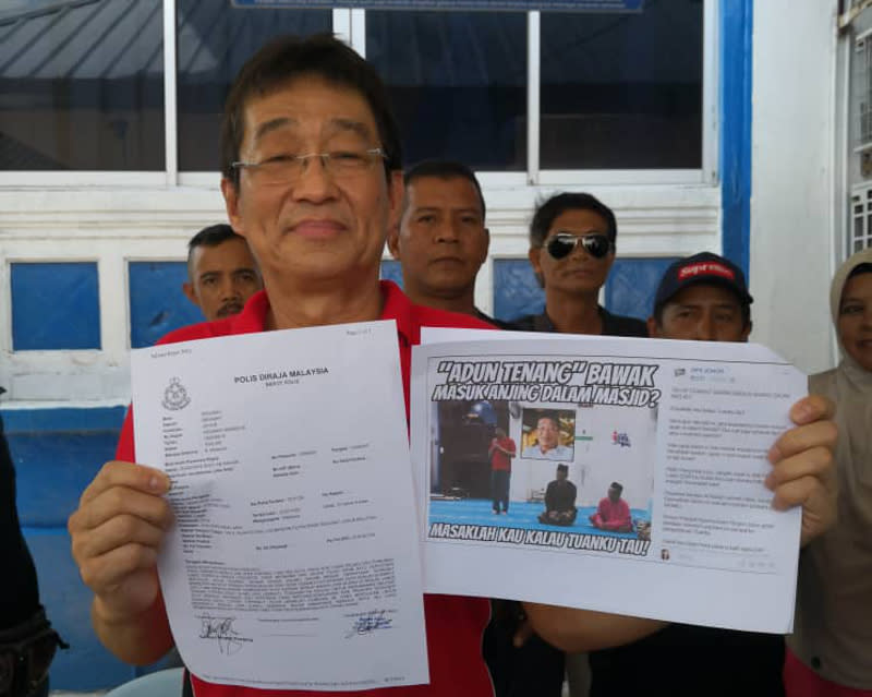 Labis MP Pang Hok Liong holding a copy of his police report and also a copy of the insulting Facebook posting after lodging a report at the Segamat police station today. — Picture courtesy of Pang Hok Liong