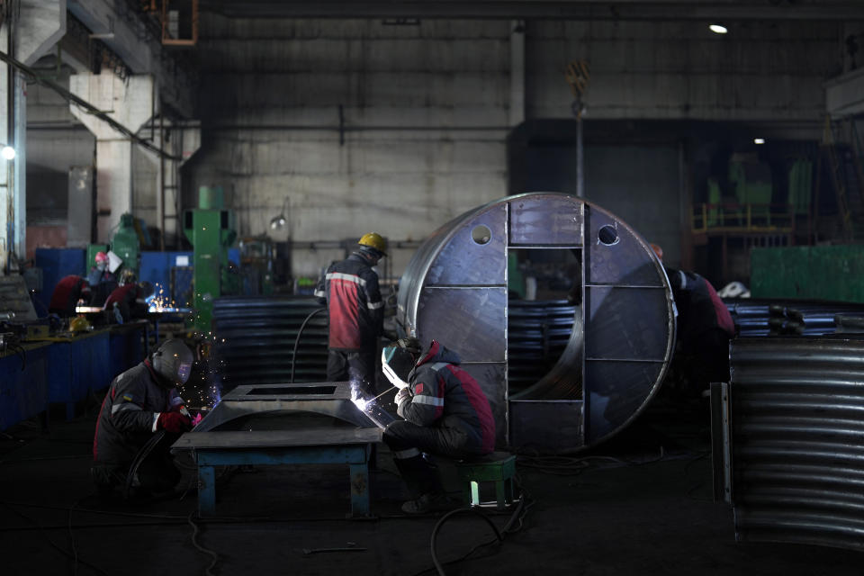 Workers weld a shelter in a plant of Metinvest company, in Kryvyi Rih, Ukraine, Thursday, March 2, 2023. The plant, which is part of Renat Akhmetov's Metinvest metals and mining holding, ships metal shelters to frontline. (AP Photo/Thibault Camus)