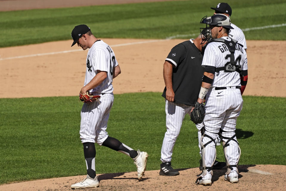 Chicago White Sox relief pitcher Zack Burdi, left, leaves the field after he was relieved by manager Rick Renteria during the seventh inning of a baseball game against the Kansas City Royals in Chicago, Saturday, Aug. 29, 2020. (AP Photo/Nam Y. Huh)