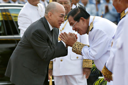 Cambodia's King Norodom Sihamoni is greeted by prime minister Hun Sen during the celebration marking the 64th anniversary of the country's independence from France, in Phnom Penh, Cambodia November 9, 2017. REUTERS/Samrang Pring TPX IMAGES OF THE DAY