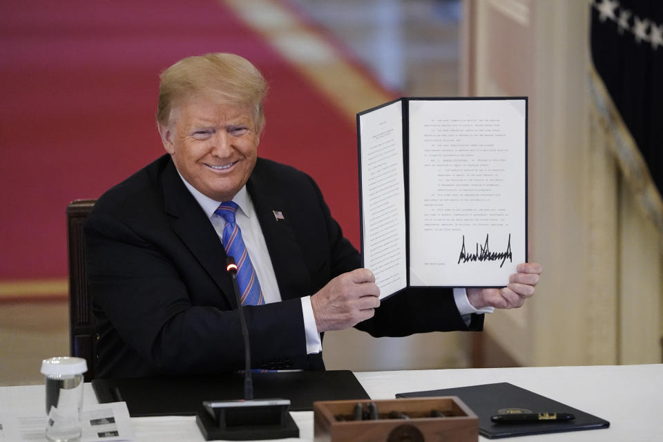 WASHINGTON, DC - JUNE 26: U.S. President Donald Trump signs an executive order related to reforming the hiring process for federal jobs in a meeting of the American Workforce Policy Advisory Board in the East Room of the White House on June 26, 2020 in Washington, DC. Earlier in the day President Trump canceled his scheduled weekend trip to his private golf club in Bedminster, New Jersey which the state now has a mandatory 14-day quarantine for travelers coming from states with coronavirus spikes. (Photo by Drew Angerer/Getty Images)