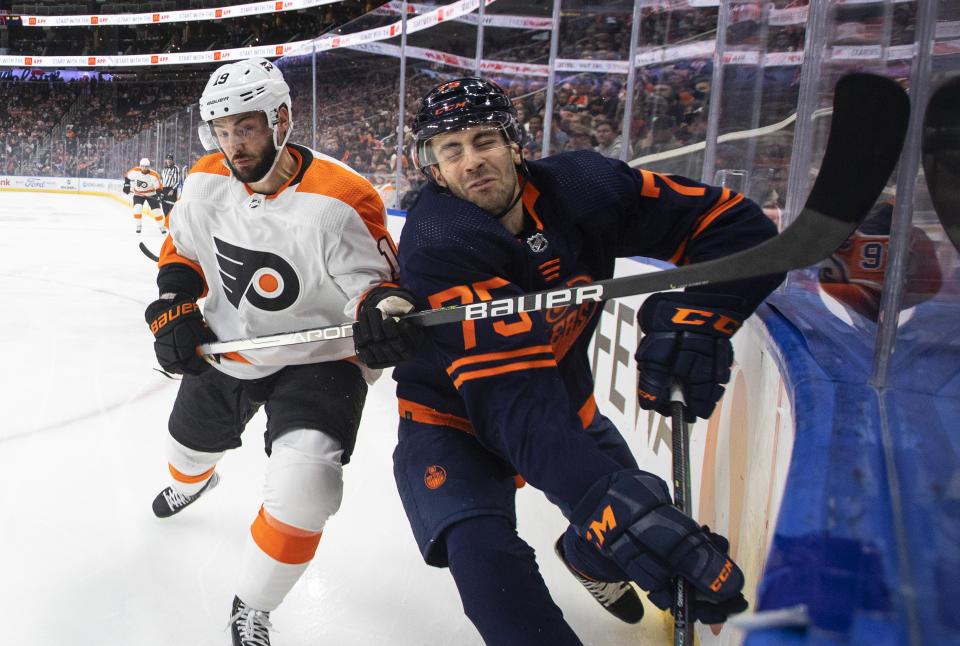 Philadelphia Flyers' Derick Brassard (19) checks Edmonton Oilers' Evan Bouchard (75) during the first period of an NHL hockey game, Wednesday, Oct. 27, 2021 in Edmonton, Alberta. (Jason Franson/The Canadian Press via AP)