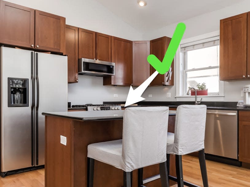 Kitchen with green checkmark pointing to island