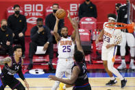 Phoenix Suns' Mikal Bridges, left, goes up for a shot against Philadelphia 76ers' Joel Embiid during the second half of an NBA basketball game, Wednesday, April 21, 2021, in Philadelphia. (AP Photo/Matt Slocum)