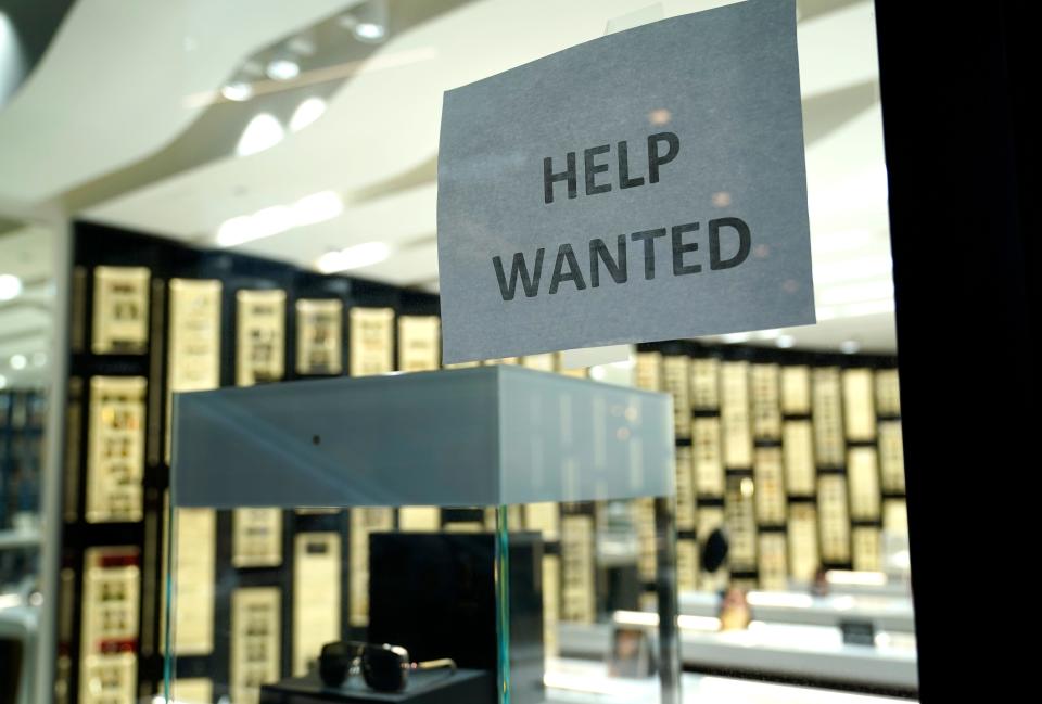 A help wanted sign is posted at a Designer Eyes store at Brickell City Centre on Nov. 6, 2020, in Miami.