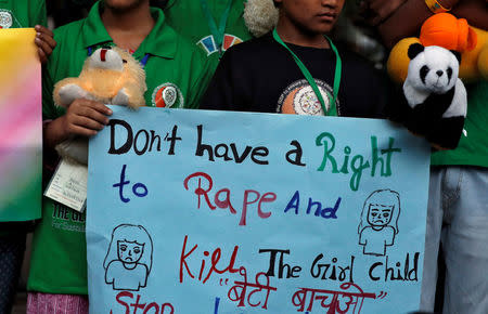 Children attend a protest against the rape of an eight-year-old girl, in Kathua, near Jammu and a teenager in Unnao, Uttar Pradesh, in New Delhi, India April 15, 2018. REUTERS/Cathal McNaughton