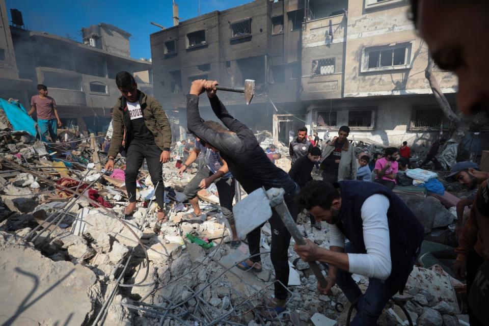 Palestinians searched for survivors after an Israeli strike on the Nusseirat refugee camp on Friday (AP Photo/Marwan Saleh)