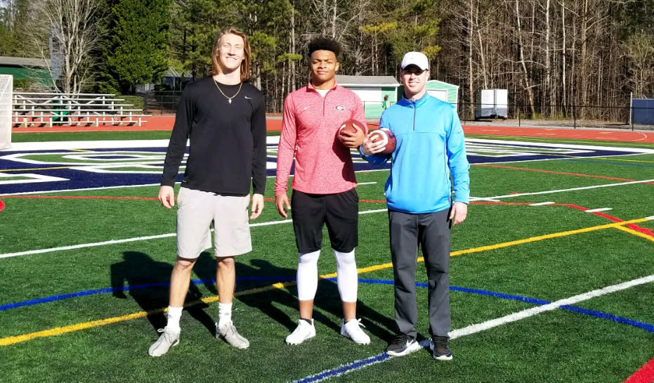 Trevor Lawrence and Justin Fields pose for a photo with Chandler Whitmer (R) after a workout at Harrison High School in Georgia. (Photo credit: Chandler Whitmer)