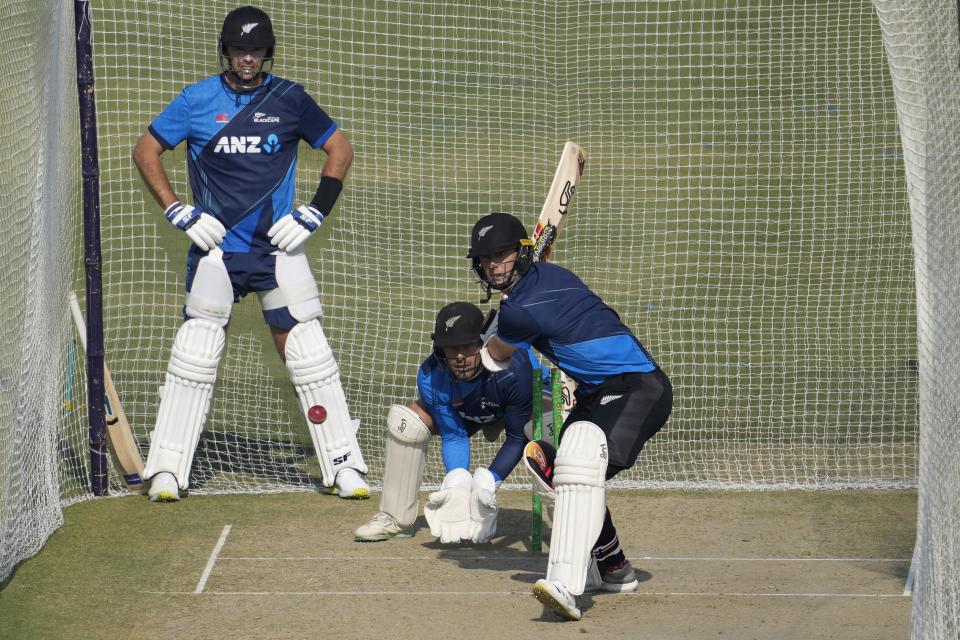 New Zealand's Matt Henry, right, bats as teammate Devon Conway, center back, and Tim Southee, left, watch during a training session, in Karachi, Pakistan, Friday, Dec. 23, 2022. (AP Photo/Fareed Khan)