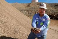 Matt Green, mining/crushing supervisor at MP Materials, displays crushed ore before it is sent to the mill at the MP Materials rare earth mine in Mountain Pass