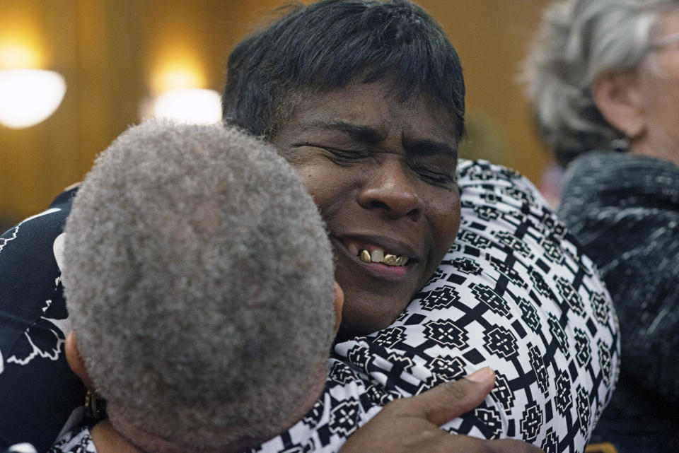 Dontae Sharpe's mother, Sarah Blakley, hugs family and friends in celebration of a judge's ruling Thursday, Aug. 22, 2019 in Greenville, N.C. Sharpe, a North Carolina man who maintained his innocence even as he served a life sentence for a murder he didn’t commit said Thursday that he got his strength in prison from God and his mother. (Deborah Griffin/The Daily Reflector via AP)