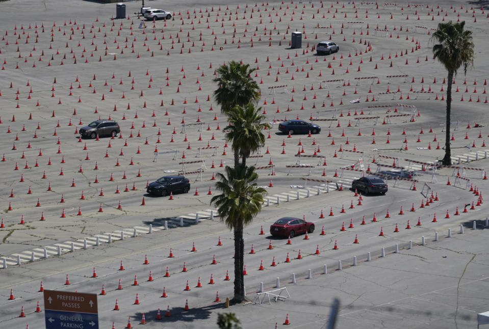 Vehicles drive around a maze of traffic cones, as they line up at the Dodgers Stadium vaccination site in Los Angeles Friday, April 2, 2021. California has administered nearly 19 million doses, and nearly 6.9 million people are fully vaccinated in a state with almost 40 million residents. But only people 50 and over are eligible statewide to get the vaccine now. Adults 16 and older won't be eligible until April 15. (AP Photo/Damian Dovarganes)