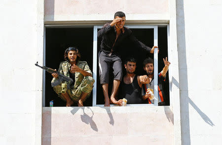 Members of Turkish-backed Free Syrian Army (FSA) are pictured as they look out from a building in the border town of Jarablus, Syria, August 31, 2016. REUTERS/Umit Bektas