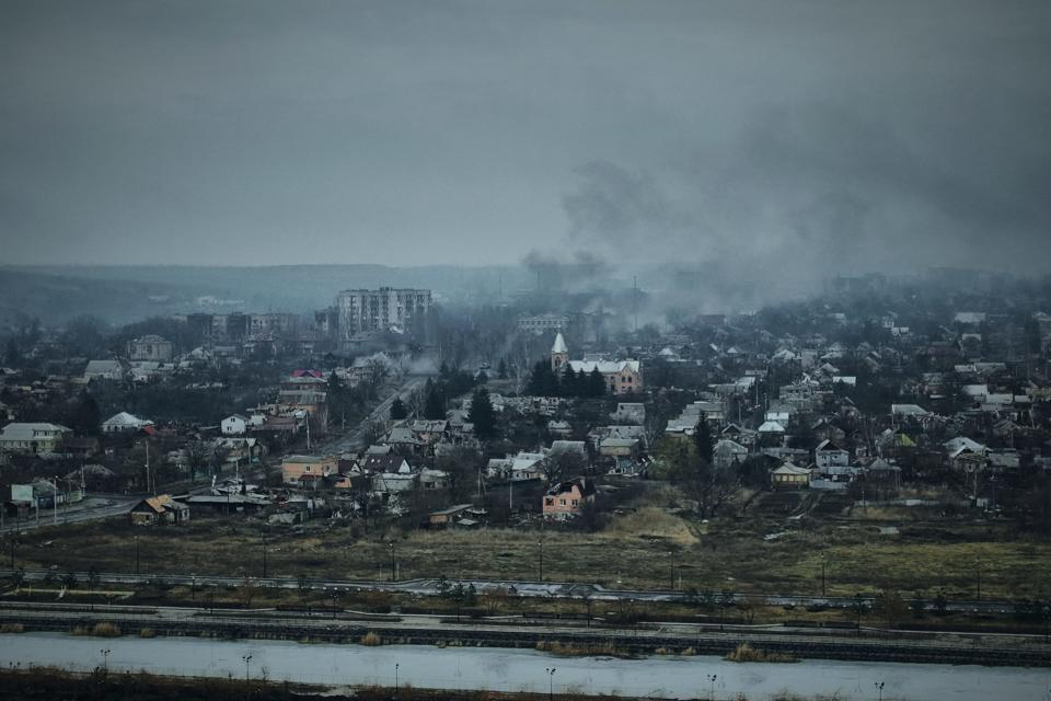 Smoke rises from buildings in an aerial view of Bakhmut, the site of heavy battles with Russian troops in the Donetsk region, Ukraine, Sunday, March 26, 2023.