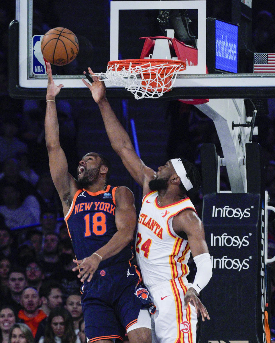 New York Knicks guard Alec Burks (18) shoots against Atlanta Hawks forward Bruno Fernando (24) during the first half of an NBA basketball game Tuesday, March 5, 2024, in New York. (AP Photo/Eduardo Munoz Alvarez)