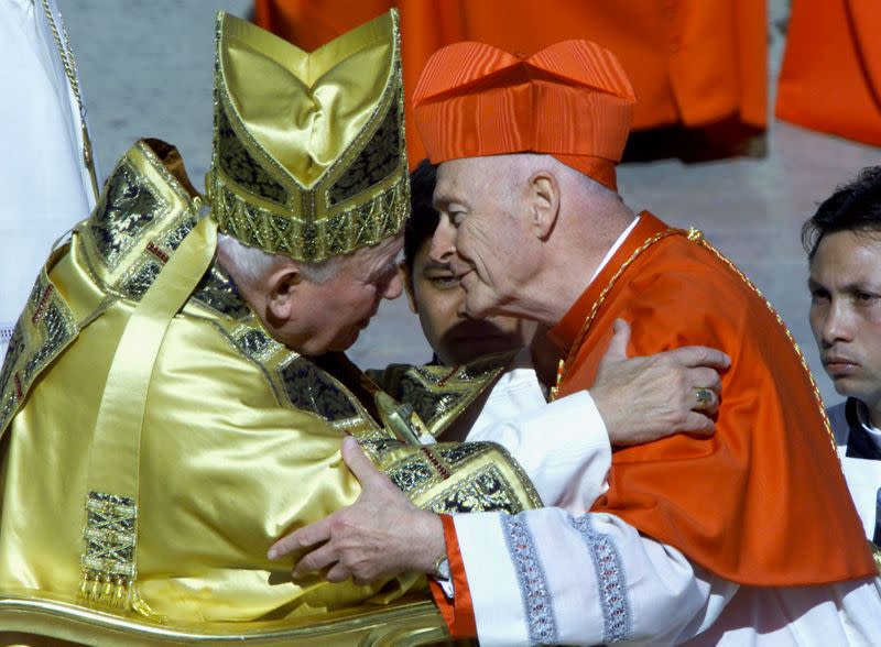 FILE PHOTO: America's new cardinal Theodore Edgar McCarrick kisses Pope John Paul II after he received the red b..