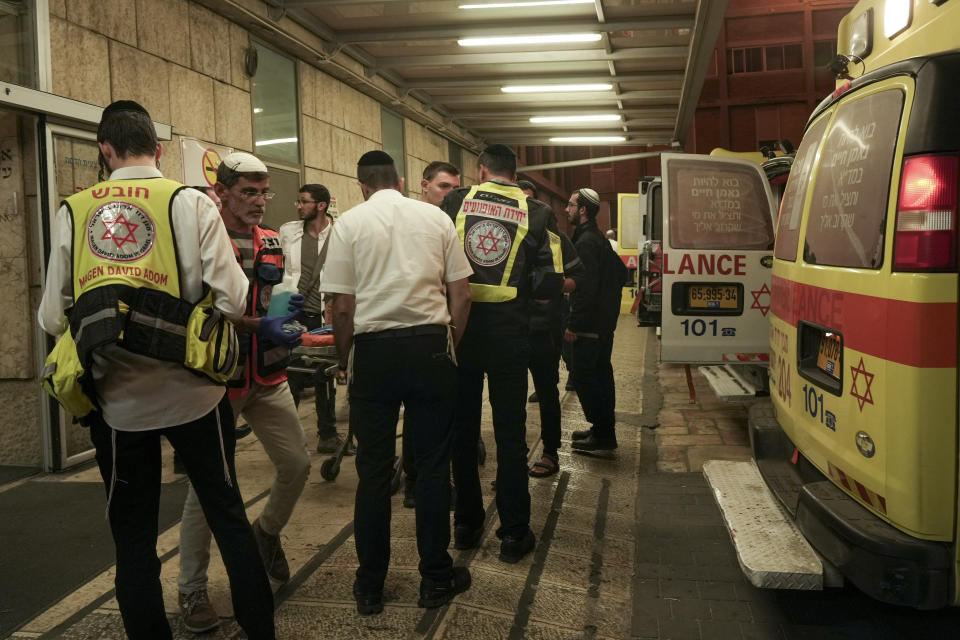 Paramedics gather at a hospital in Jerusalem on Saturday, Oct. 29, 2022, after they evacuated wounded from a shooting attack. A Palestinian militant fired at the entrance to an Israeli settlement in the occupied West Bank Saturday evening, the Israeli military said, wounding several civilians before a security guard shot him dead. (AP Photo/Mahmoud Illean)