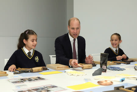 Britain's Prince William joins local school children from St Cuthbert with St Matthias CE Primary School at a copper beating workshop during the official opening of Japan House in London, Britain, September 13, 2018. Tim P. Whitby/Pool via REUTERS