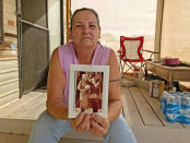 Tama DeRosier, 58, shows a photo of her husband Robert, at her mobile home in Mohave Valley, Arizona, U.S., December 3, 2017. REUTERS/Reade Levinson