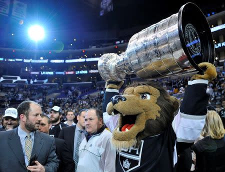 Jun 13, 2014; Los Angeles, CA, USA; The Los Angeles Kings mascot Bailey hoists the Stanley Cup after defeating the New York Rangers in second overtime during game five of the 2014 Stanley Cup Final at Staples Center. Mandatory Credit: Gary Vasquez-USA TODAY Sports