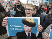 <p>Demonstrators carry posters depicting Russian President Vladimir Putin during a massive protest rally in St.Petersburg, Russia, Saturday, May 5, 2018. Alexei Navalny, anti-corruption campaigner and Putin’s most prominent critic, called for nationwide protests on Saturday, two days ahead of the inauguration of Vladimir Putin for a fourth term as Russian president. The sign on poster reading “He is not our czar”. (Photo: Dmitri Lovetsky/AP) </p>
