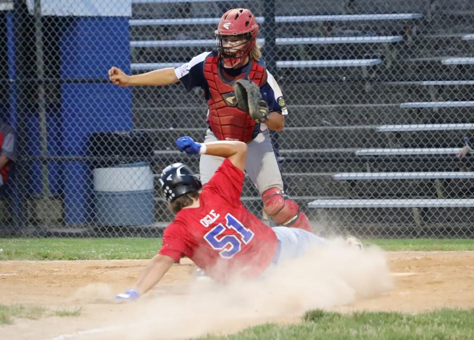 Cambridge Post 84's slides home to score a run before Zanesville catcher AJ Harper can make the tag during Friday's 8-0 victory over Zanesville Post 129 in action in the 30th annual Don Coss Invitational tournament at Don Coss Stadium.