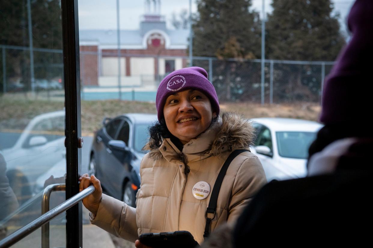 Canvasser Ligia Gomez of Takoma Park, Md., enters an apartment building in January 2020 to ask residents to pledge that they will fill out the 2020 census. Once COVID-19 arrived, lockdowns and other restrictions made it harder for canvassers and census workers to gain access to apartment buildings.
