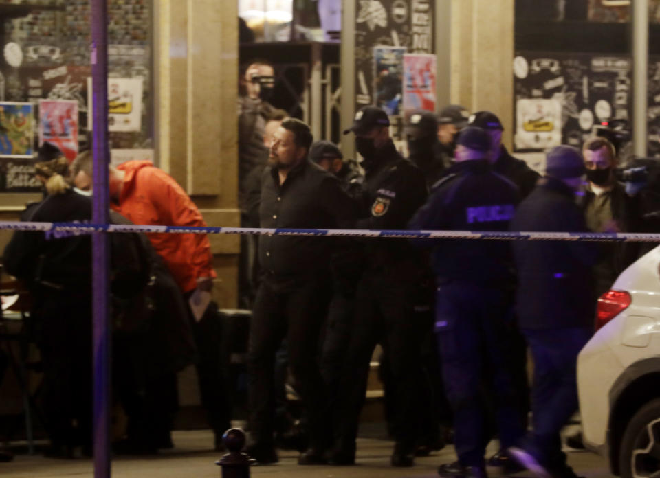 Police surround a bar which they have raided and whose owner they have arrested for operating illegally in defiance of pandemic restrictions in Warsaw, Poland, Friday March 26, 2021. A raft of new pandemic restrictions take effect in Poland on Saturday to slow the spread of infection in what has become of the new global hot spots for the virus – but even earlier restrictions are being defied by some.(AP Photo/Czarek Sokolowski)