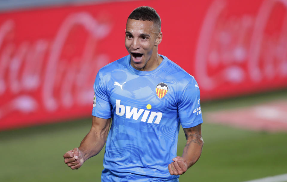 FILE - In this June 18, 2020 file photo, Valencia's Rodrigo Moreno celebrates after scoring his side's opening goal during their Spanish La Liga soccer match against Real Madrid at Alfredo di Stefano stadium in Madrid. Leeds has marked its return to the Premier League by signing forward Rodrigo from Valencia to break the club’s transfer record after 20 years, it was announced Saturday, Aug. 29, 2020. The 29-year-old Spain international reportedly cost Leeds around 30 million pounds ($40 million). (AP Photo/Manu Fernandez)