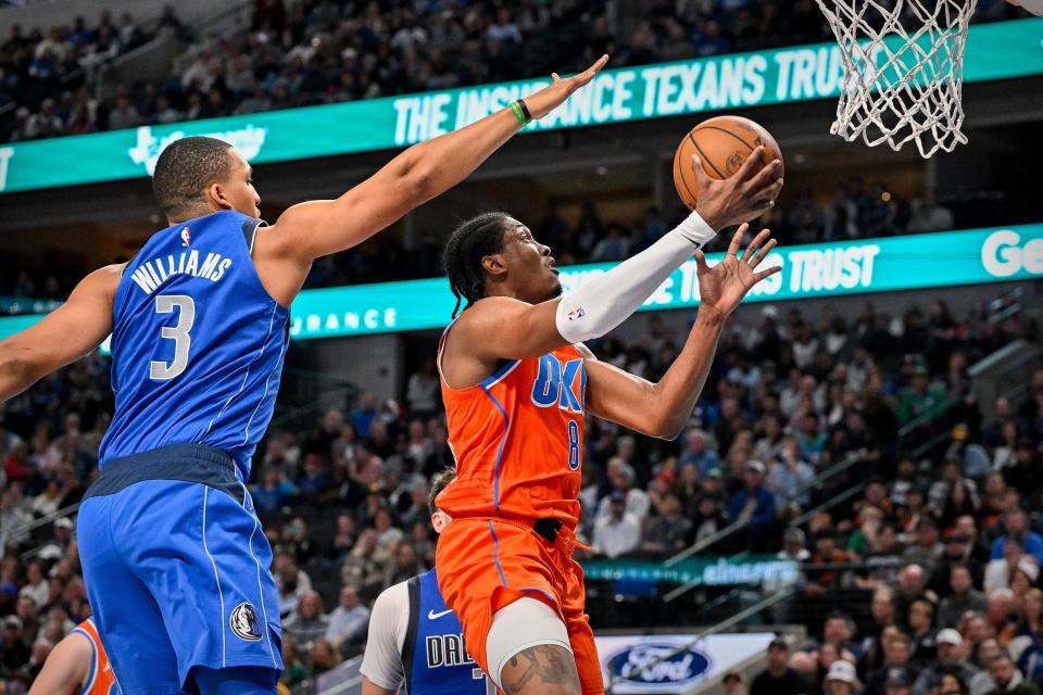 Oklahoma City forward Jalen Williams, right, drives to the basket past Dallas forward Grant Williams during the second quarter Saturday at American Airlines Center in Dallas.