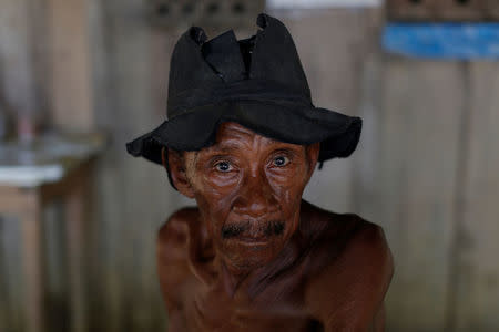 A man poses for a camera at an illegal gold mine during "Operation Green Wave" conducted by the Brazilian Institute for the Environment and Renewable Natural Resources, or Ibama, to combat illegal logging in Apui, in the southern region of the state of Amazonas, Brazil, August 5, 2017. REUTERS/Bruno Kelly