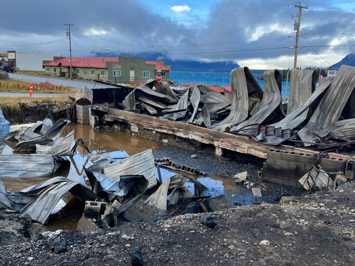 The charred remains after a fire destroyed the post office and general store in Atlin, B.C. Canada Post is seeking a new postmaster who can 