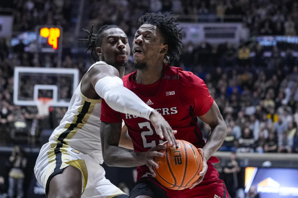 Purdue guard Lance Jones (55) fouls Rutgers guard Jeremiah Williams (25) during the first half of an NCAA college basketball game in West Lafayette, Ind., Thursday, Feb. 22, 2024. (AP Photo/Michael Conroy)