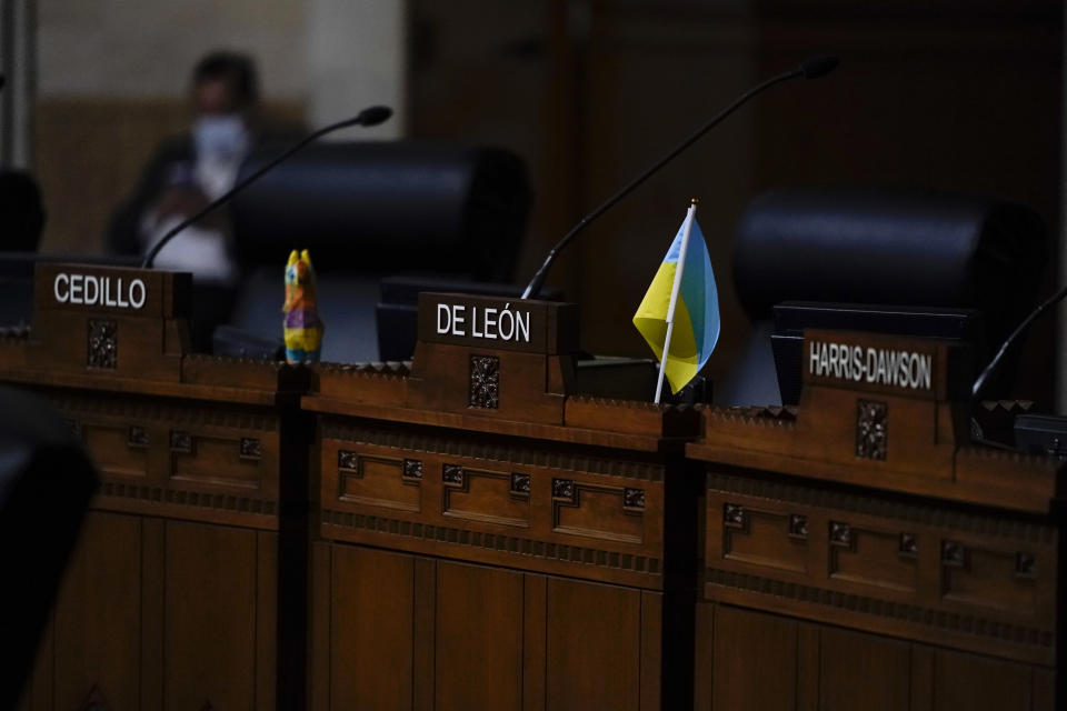 Empty seats of city councilmembers, Gil Cedillo, Kevin de León and Marqueece Harris-Dawson are seen during a virtual meeting at the Los Angeles City Hall in Los Angeles, Tuesday, Oct. 18, 2022. The demonstrators demanded the city council stop its virtual meeting Tuesday until two of its members resign over racist remarks. (AP Photo/Jae C. Hong)