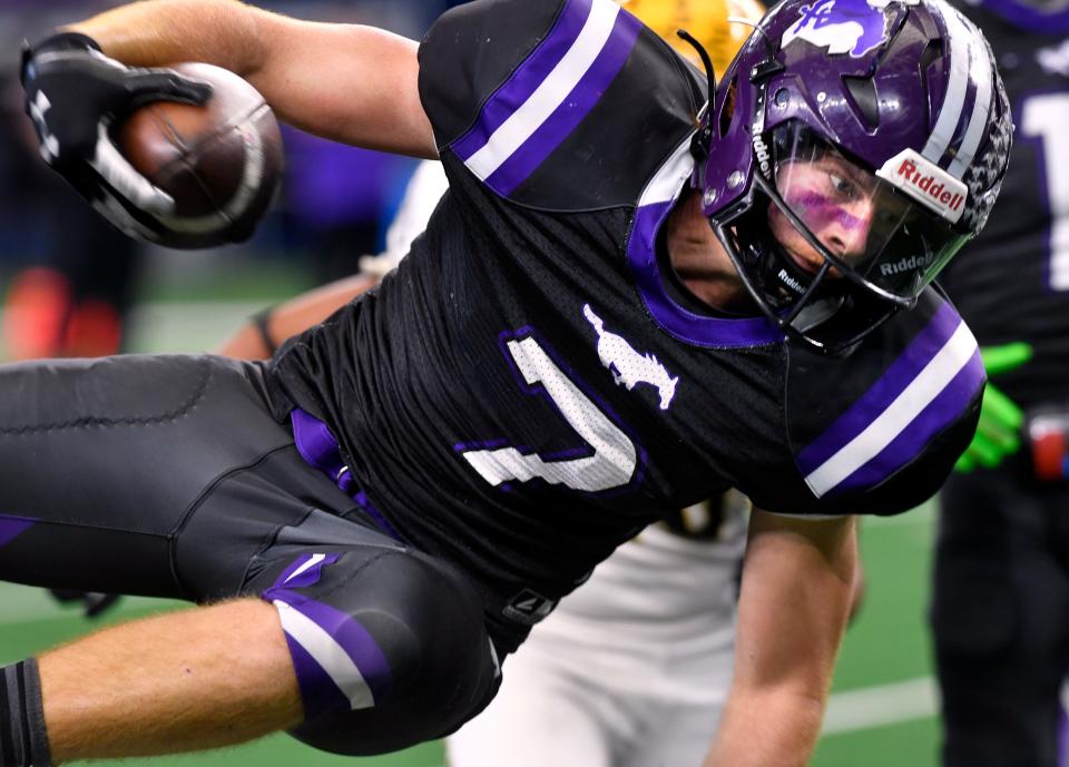 Benjamin running back Brody White leaps for a touchdown against Loraine during the Class 1A Div. 2 state championship football game at AT&T Stadium in Arlington. White's Mustangs won.