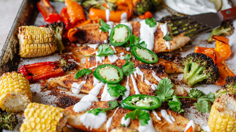 Tilapia sheet pan with jalapeño, fish spatula and sour cream