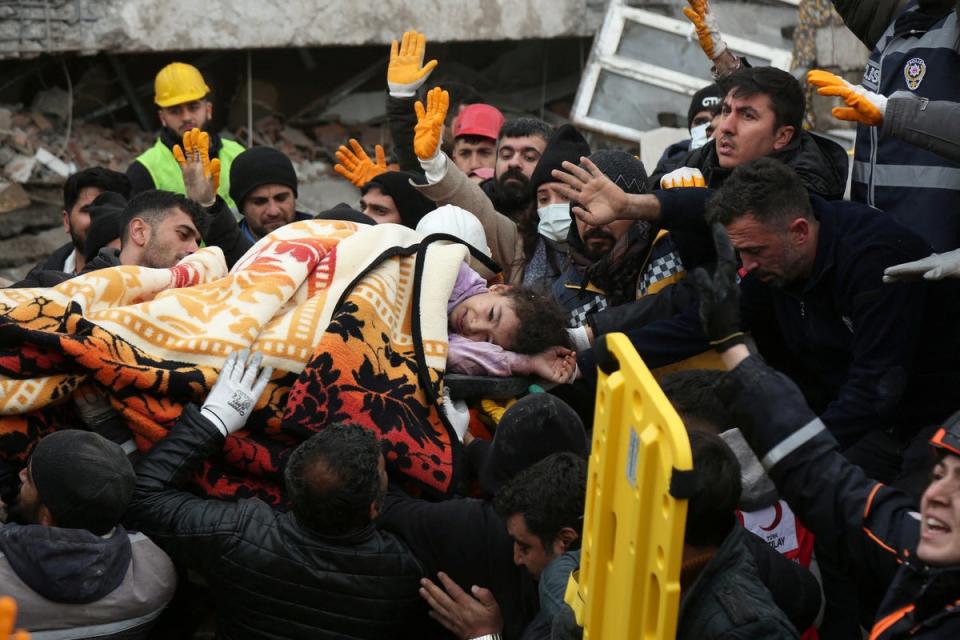 Rescuers carry out a girl from a collapsed building following an earthquake in Diyarbakir, Turkey (REUTERS)