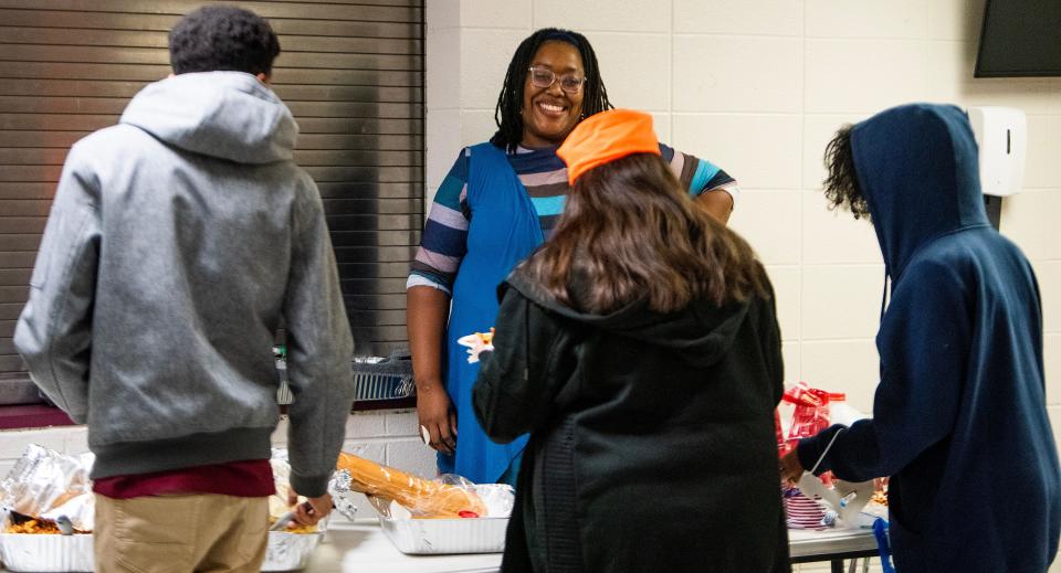 Desiree Carmichael serves dinner for the Jefferson County Academy of Theater and Dance during a rehearsal at Shades Valley High School in Irondale, Ala., on Nov. 2, 2023. Carmichael, who said she averages about six hours of sleep nightly, knows she could be sleeping more but finds herself consumed by daily chores she doesn't have time to get to as a single mom.